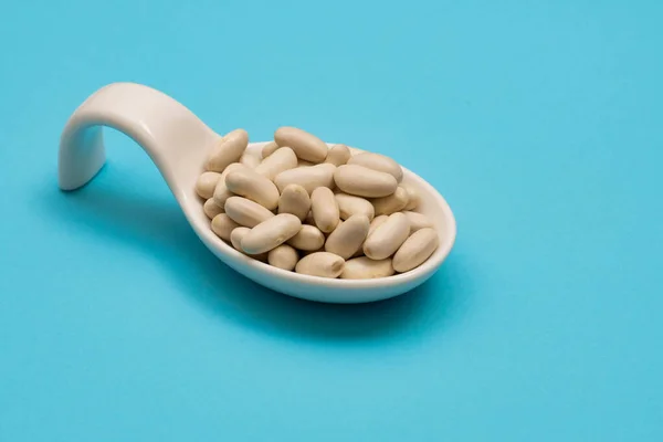 White Ceramic Spoon White Beans Blue Bottom — Stock Photo, Image