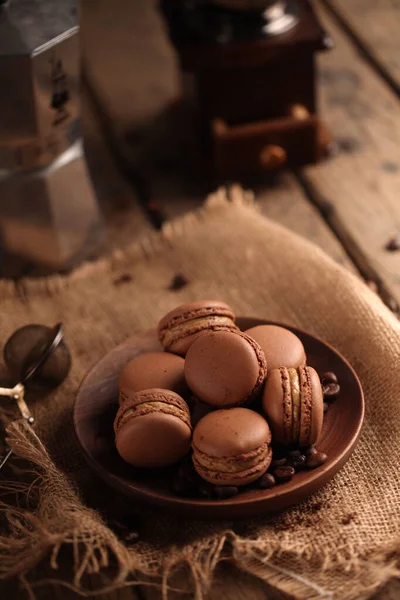 Ahşap bir masada kahverengi örgü kumaş üzerindeki kahverengi badem kurabiyelerinin üst görüntüsü.
