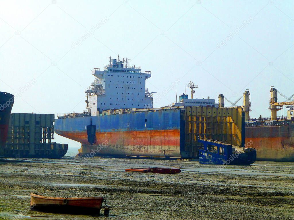 Old ocean ship being broken down in a ship breaking yard in Chittagong, Bangladesh. All pieces are then sold and metal melted to be reused.