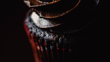 Siyah arka planda izole edilmiş çikolatalı kekin yakın çekimi.