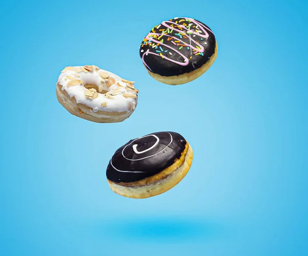 Dark Chocolate Vanilla Sweet Donuts Sprinkles Flying Blue Background — Stock Photo, Image