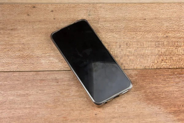 Eine Nahaufnahme Des Alten Schwarzen Smartphones Auf Dem Holztisch — Stockfoto