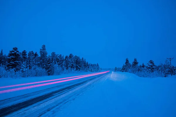 Long Exposure Snow Covered Road Red Light Surrounded Trees Evening — Stock Photo, Image