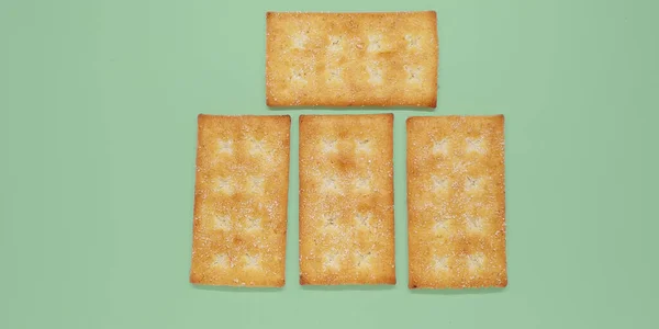 Closeup Shot Four Biscuits Different Positions Green Background — Stock Photo, Image