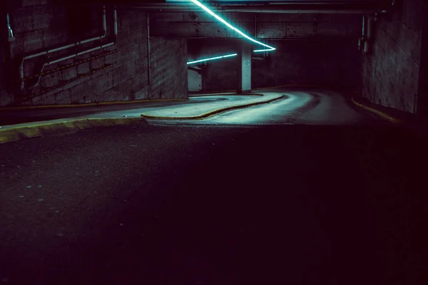 A high angle of a dark down road underground to the parking lot