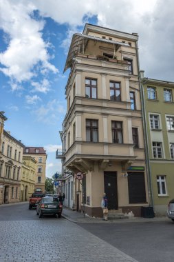 Polonya 'nın Torun kentindeki geleneksel binaların altına park edilmiş arabaların dikey görüntüleri.