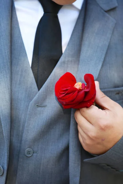 Ένα Κάθετο Πλάνο Ενός Γαμπρού Που Κρατάει Ένα Κόκκινο Λουλούδι — Φωτογραφία Αρχείου