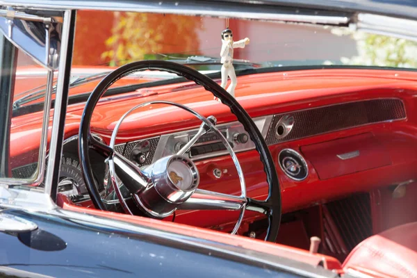 Red Classic Car Interior Singing Elvis Figurine Dashboard Stock Photo