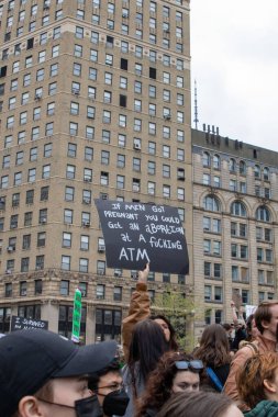 A crowd holding a cardboard sign Foley Square, New York, NY, USA 05-03-2022 Protesters holding signs