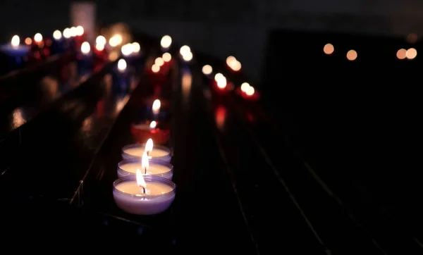 Closeup Burning Candles Blurry Dark Background Selected Focus — Stock Photo, Image