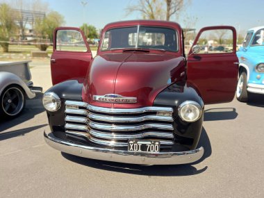 Old red and black pickup truck Chevrolet Thriftmaster 1947 by GM. Doors open. Utility or farming tool. Front view. Expo Fierros 2021 classic car show clipart
