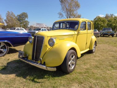 Eski sarı Morris Ten Serisi M dört kapılı salon 1938 - 1948 kırsal kesimde. Yeşil doğa çimleri ve ağaçların arka planı. Klasik araba şovu. Kopyalama alanı