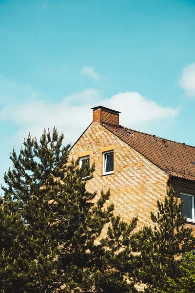 A vertical shot of the house roof against the blue sky. Hamburg, Germany.