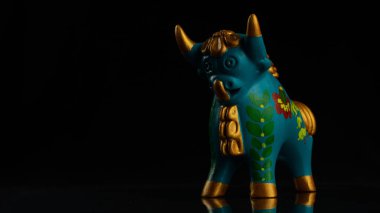 Pukara 'lı mavi bir boğanın yakın plan resmi. Siyah bir arka planda, kopyalama uzayında izole edilmiş.