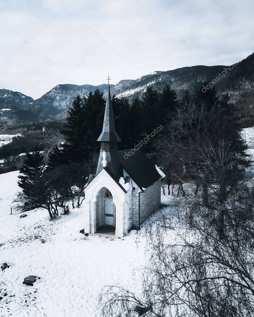 A vertical shot of a beautiful historical church in the French Jura mountains, Geneva, Switzerland