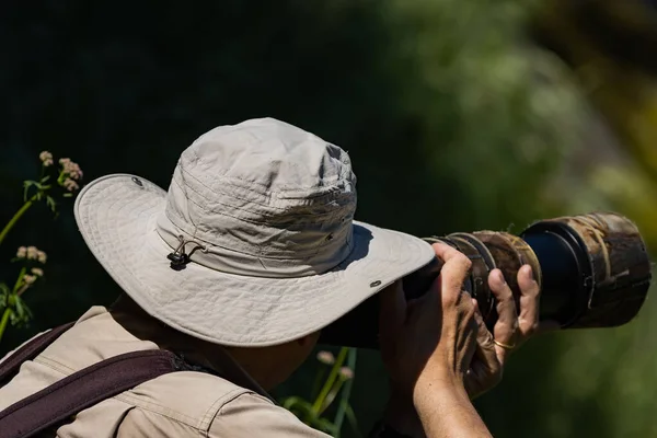 First wildlife photographer\'s plan using a camouflage-coated telephoto lens.