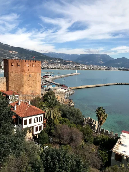 An old medieval castle by the sea with a blue sky on the background