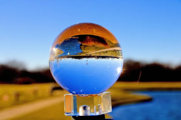 Una Palla Vetro Uno Stand Con Riflesso Campo Oro Cielo — Foto Stock