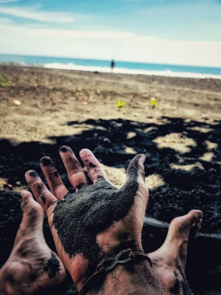 Vertical Closeup Male Holding Black Sand His Palm Sitting Beach — Stock Photo, Image