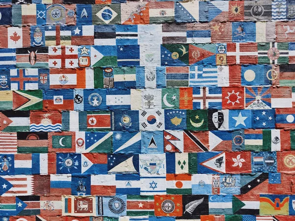 Closeup Shot Old Wall Painted Different Flags Symbols — Stock Photo, Image