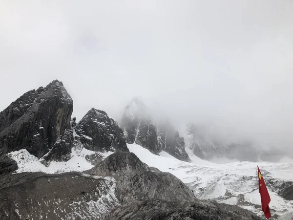 那雪山的景色隐藏在雾中的岩石顶上 — 图库照片