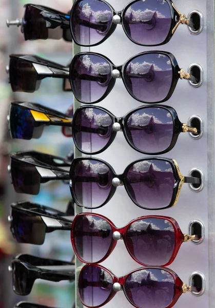 many sunglasses on stand in the store, market, moder