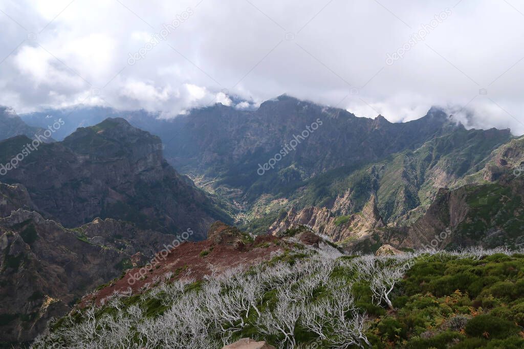 Rugged mountain landscape along a king trail between Pico Ruivo and Pico Arierio on Madeira, Portugal