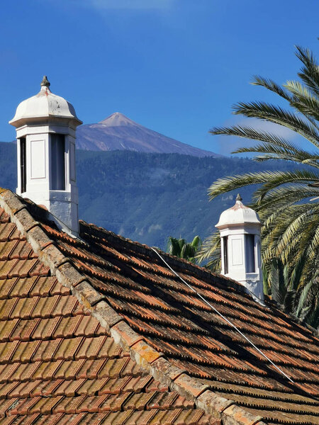 A vertical shot of the roof of the English library of Puerto de la Cruz with the Tiede volcano in the background