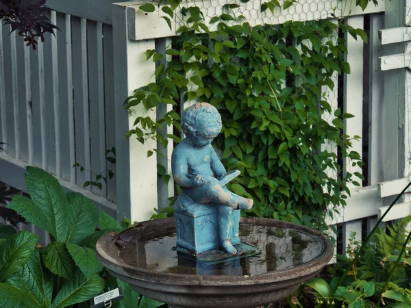 Closeup Blue Small Statue Baby Reading Book Birdbath Garden — Stock Photo, Image