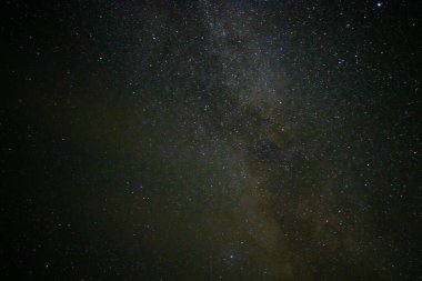 Gece gökyüzünde parlayan yıldızlarla Samanyolu 'nun manzarası.