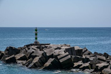 Portekiz, Madeira 'da mavi okyanus arka planında bir deniz fenerinin manzarası