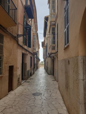 A vertical shot of buildings with a narrow road
