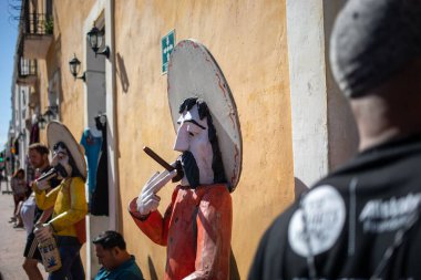 A closeup of cigar smoking statues on the streets in Valladolid, Mexico on a sunny day