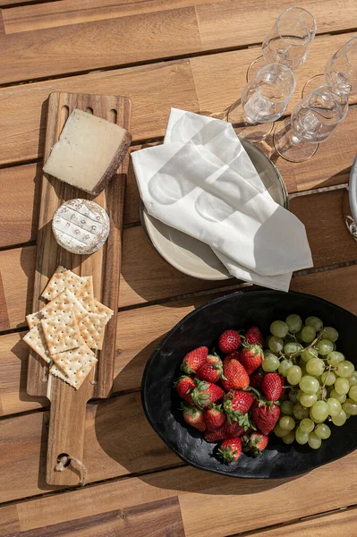 Top View Fruits Cheese Crackers Plates Champagne Glasses Wooden Table — Stock Photo, Image