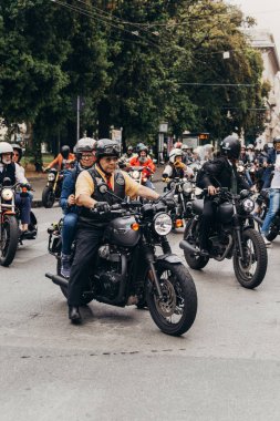 A vertical shot of riders at the Distinguished Gentleman's Ride, a fund-raising event to fight prostate cancer, Genova, Italy