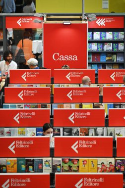 A vertical shot of the people in Feltrinelli Italian publishing house booth at the international book fair. Turin, Italy.