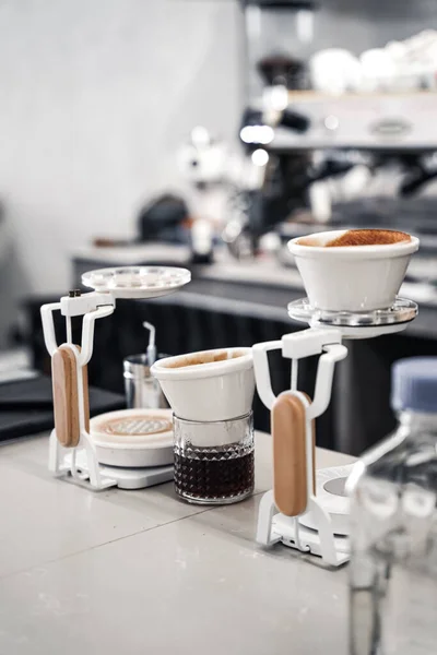 a vertical shot of coffee grinders with pour-over coffee