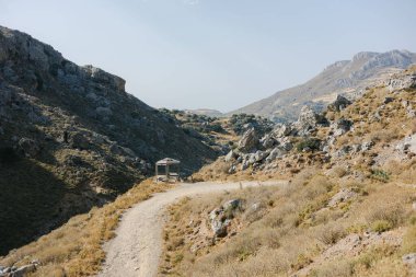 A bright summer day outdoors at the Kourtaliotis Gorge in Rethymno, Greece under a blue sky