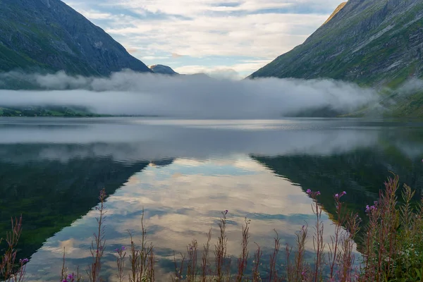 A beautiful shot of Eidsvatnet lake and mountains with reverse reflection