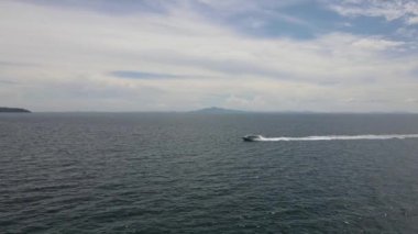 A view of a driven boat in the turquoise colored sea of Phi Phi island