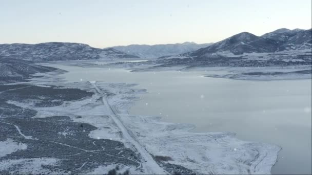 Aerial View Snowing Frozen Lake Mountains — Stockvideo