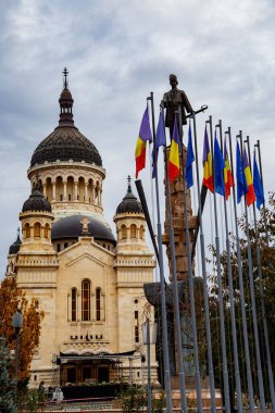 A vertical of the statue of Avram Iancu against the Cathedral of the Assumption of the Blessed Virgin Mary in Romania