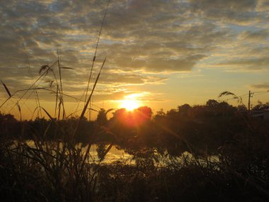 A beautiful shot of the colorful sunset behind the clouds