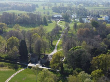 The bird's eye view of the beautiful park with green vegetation under sunlight. Leeds, Kent, England.