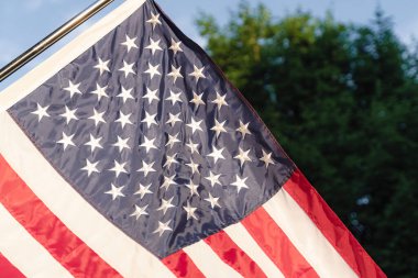 A US flag on a pole waving in the wind
