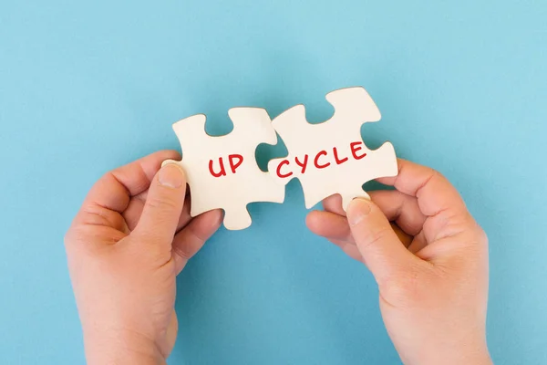 The word up cycle is standing on puzzle pieces, environmental conversation, reuse and repair concept, responsibility with resources, zero waste
