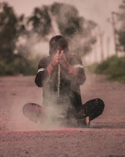 Vertical Closeup Young Man Sitting Ground Spraying Colored Powder — Zdjęcie stockowe