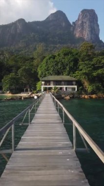 A beautiful view of a Minang Cove Resort in Tioman island, Malaysia.Wooden bridge across the river on the background of mountains
