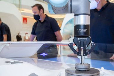 robotic arm with people controlling at back