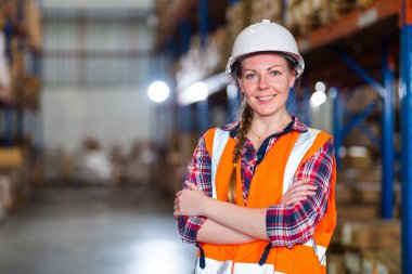 A portrait of a Caucasian warehouse worker standing in a distribution center - the concept of occupation and career